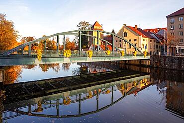 Autumnal coloured trees with iron bridge over the river Maltsch with the city wall of the historical old town of Ceske Budejovice, ?eske Bud?jovice, South Bohemia, Bohemia, Czech Republic, Europe