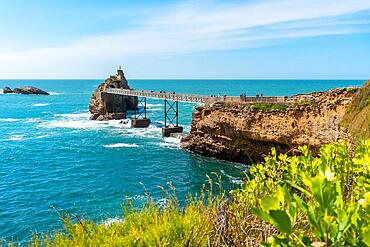 Wooden footbridge over the sea in Biarritz, Rocher de la Vierge in summer. Municipality of Biarritz, department of the Atlantic Pyrenees. France