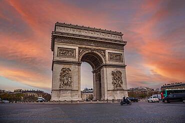 Orange sunset at the Arc de Triomphe in the beautiful European city of Paris. France