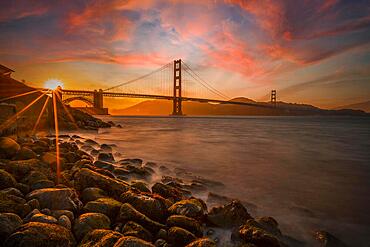 Gorgeous orange sunset with pink clouds over the Golden Gate in San Francisco, California. United States