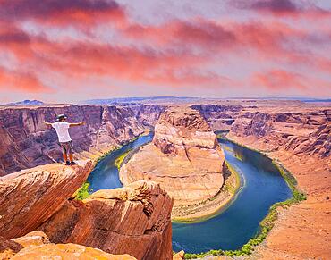 A young man with white shirt and green hat in Horseshoe Bend, Arizona. United States