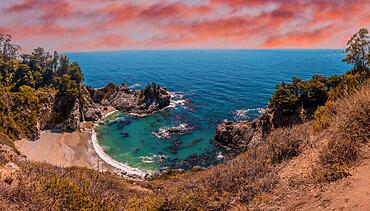 Mcway Waterfall and its beautiful beach in sunset, California. United States