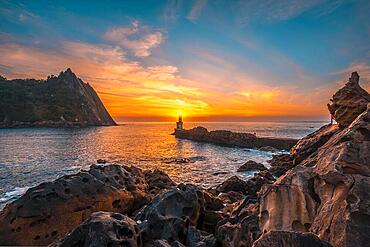 The sun hiding in the Lighthouse in Pasajes San Juan near San Sebastian, Guipuzcoa. Basque Country