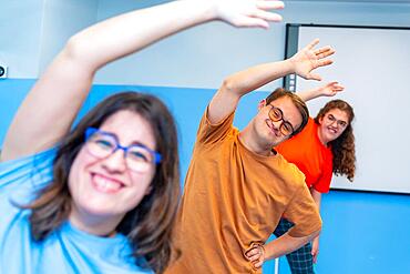 Selective focus on a man with down syndrome and friends enjoying gym class