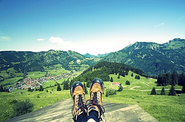 Mountain boots on alpine pasture with blue sky