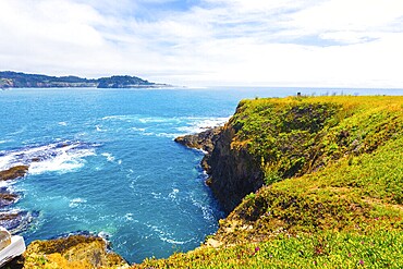 Beautiful rocky coastline and churning ocean below cliffs near Mendocino Bay on sunny day in California. Horizontal