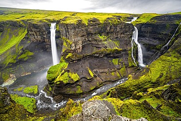 River and waterfalls at a canyon with green moss, Haifoss and Granni waterfall at a canyon, Fossá í Þjórsárdal, with river í Þjórsárdal, long exposure, dramatic landscape, Hekla, Iceland, Europe