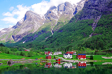 Norwegian village by the fjord with colourful houses in front of majestic mountains and green forest, Balestrand, Gaular, Norway, Europe