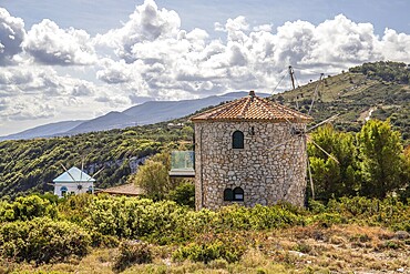 Great typical Greek windmill in the evening. In the Mediterranean architectural style of Greece. It stands on a cliff in the Mediterranean. Potamitis windmill, Ionian Islands, Greece, Europe