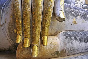 Hand of a Buddha statue decorated with gold leaf (Bhumispara-mudra: Buddha Gautama at the moment of enlightenment), Wat Si Chum, Historical Park Sukhothai, Sukhothai, Thailand, Asia