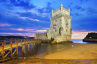 Belem Tower or Tower of St Vincent, famous tourist landmark of Lisboa and tourism attraction, on the bank of the Tagus River (Tejo) after sunset in dusk twilight with dramatic sky. Lisbon, Portugal, Europe