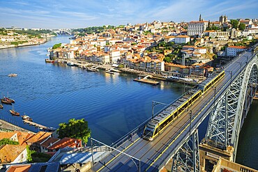 View of Porto city and Douro river and Dom Luis bridge I with metro tram from famous tourist viewpoint Miradouro da Serra do Pilar. Porto, Vila Nova de Gaia, Portugal, Europe