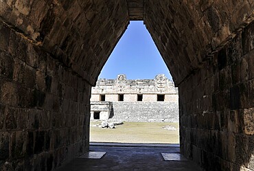 Unesco World Heritage Site, the Mayan ruins of Uxmal, Yucatan, Mexico, Central America, view through a stone tunnel to ancient ruins with open sky in the background, Central America