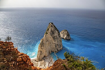 Viewpoint with a view of a landscape on a coast with Mediterranean flair. Taken in the morning light with sun and haze over the sea. the Myzithres Rock, Ionian Island of Zakynthos, Greece, Europe