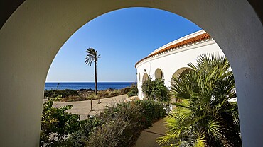 View through an arch of a circular building to the sea, surrounded by green plants and bushes, thermal springs, thermal baths, thermal baths of Kallithea, Kallithea, Rhodes, Dodecanese, Greek Islands, Greece, Europe