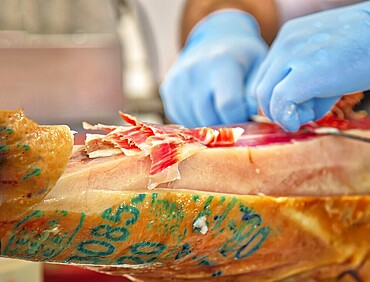 Famous street market near Barcelona Cathedral in Las Ramblas, Jamon Serrano preparation stand