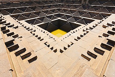 A now empty reservoir or tank was used in ancient times for storing water in Hampi, Karnataka, India. horizontal