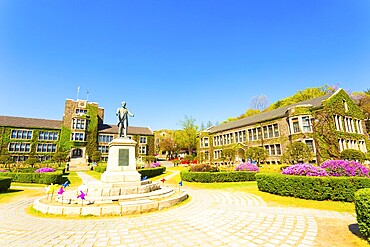 Ivy covered brick buildings surround the quad with Horace Grant Underwood statue at venerable Yonsei University in Sinchon, Seoul, South Korea. Horizontal