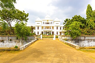 Driveway entrance to the Jaffna Public Library housed in a white British colonial building on a overcast day in Sri Lanka. Horizontal