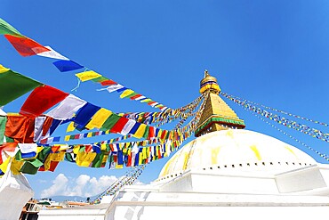 Prayer flags on white second level of Boudhanath Stupa in Kathmandu, Nepal on October 23, 2013. Horizontal