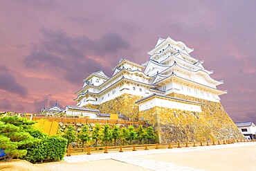 Wide yard below at the base of Himeji-jo castle on a colourful sunset evening in Himeji, Japan after newly renovated early 2015. Angled horizontal copy space