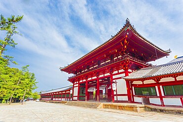 Angled front red gate ro-mon entrance to historic Todai-ji, Todaiji, temple housing the Daibutsuden on a beautiful blue sky morning in Nara, Japan. Horizontal copy space