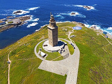 Majestic lighthouse on the coast with green grass and deep blue sea under a bright blue sky, aerial view, Torre de Hércules, Torre de Hercules, Roman Tower of Hercules, A Coruña, A Coruna, La Coruña, La Coruna, Galicia, Spain, Europe