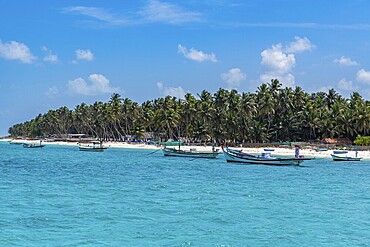 Little boats before a palm fringed white sand beach, Agatti Island, Lakshadweep archipelago, Union territory of India