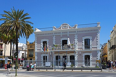 Large historical building with palm trees in front of it, people at a crossroads, Ayuntamentio, town hall, Sanlúcar de Barrameda, Sanlucar, Cádiz, Cadiz, Andalusia, Spain, Europe