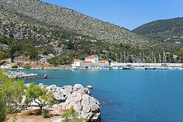 Harbour with boats in front of a picturesque mountainous landscape by the sea, harbour of Methana, spa in the background, peninsula Methana, Argolis, Saronic Islands, Peloponnese, Greece, Europe