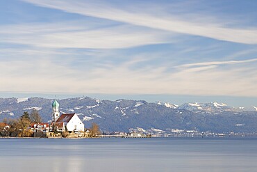 Picturesque church of St. George on the lakeshore in front of snow-covered Pfänder on a clear winter day, moated castle, Lake Constance, Bavaria, Germany, Europe