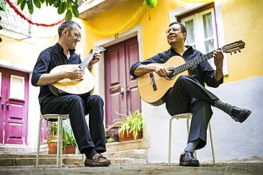 Two fado guitarists with acoustic and portuguese guitars in Alfama, Lisbon, Portugal, Europe