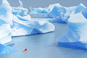 Kayaker on lake, icebergs on Lago Grey, Torres del Paine National Park, Patagonia, Chile, South America