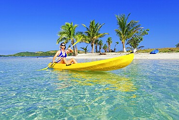 Woman in yellow kayak, Yasawa, Fiji Island