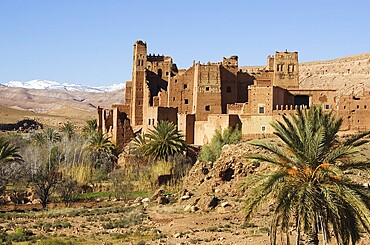 View of Tamdaght Kasbah near to Aït Benhaddou, the High Atlas mountains in the back, Southern Morocco