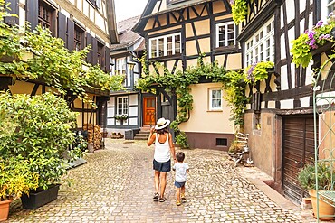 Mother and son in the medieval village in the old town of Gengenbach in the Black Forest, Germany, family vacation concept, Europe