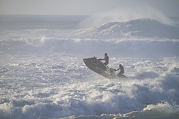 Jet ski jumping over a wave in the stormy Atlantic Ocean, Nazaré, Portugal, Europe