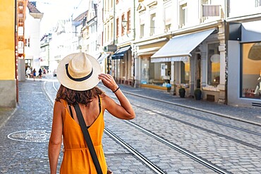 A woman walking through the city of Freiburg im Breisgau, Germany, Europe