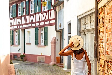 A female tourist walking in the village of Gengenbach in the Black Forest, Germany, Europe