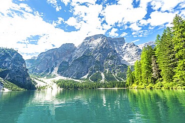Emerald waters reflecting the majestic dolomites peaks at lake braies, a stunning natural wonder in the heart of the italian alps
