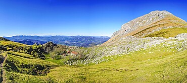 Scenic view of a hiking trail ascending towards mount txindoki, showcasing the natural beauty of the basque country in gipuzkoa