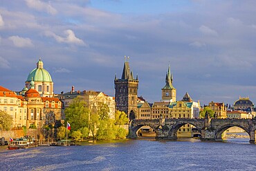 Charles Bridge (Karluv Most) on Vltava river and Old Town Bridge Tower, famous tourist destination in Prague, Czech Republic (Czechia), at sunset