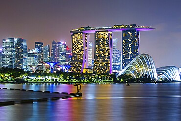 Marina Bay Sands and Gardens By The Bay with city skyline at dusk