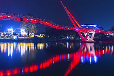 The Bridge of Kuching on Borneo illuminated in the evening
