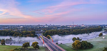 Sunrise and the first rays of sunshine over the fog-covered Ruhr meadows in Duisburg, Germany, Europe