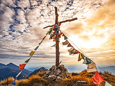 Wood cross on a mountain peak