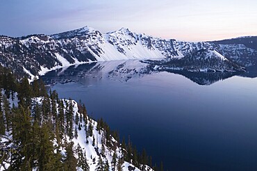 Stillness in the water and clear skies in Crater Lake National Park Oregon State North America