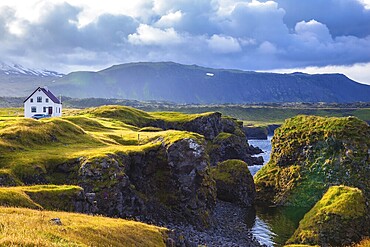 Sunset in the fishing village of Arnastapi. Quiet summer evening on the coast of Iceland