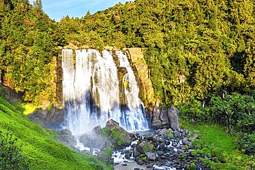 North Island. The largest and widest waterfall in Marocopa. The setting sun illuminates the stormy and thundering jets of water and snow-white foam. The magical beauty of New Zealand