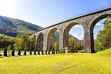Picturesque Julian Alps. Beautiful sunny autumn day. Majestic powerful bridge over the river Idrija. The beauty of the Julian Alps. Travel to Slovenia